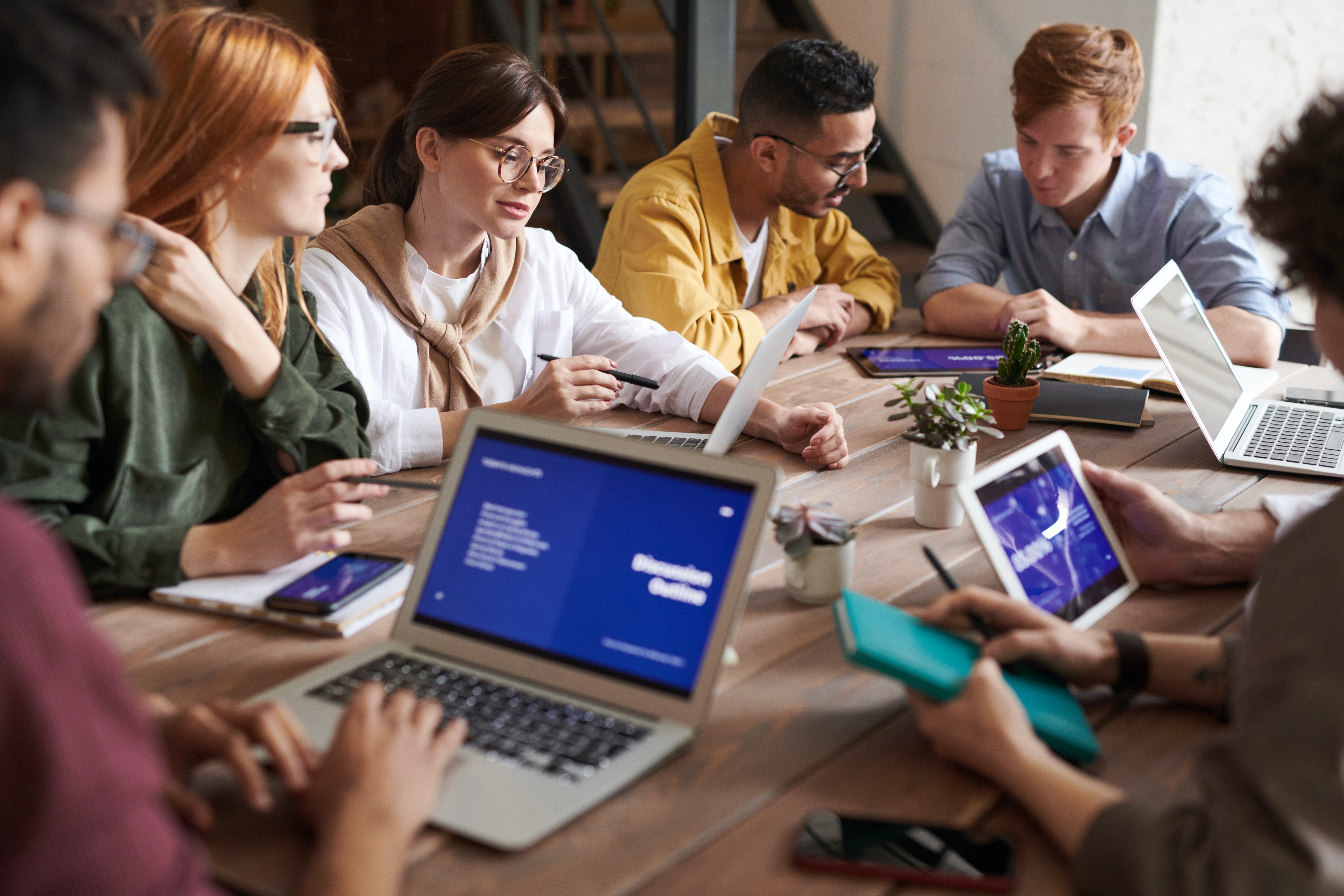 Employees building trust and engaging around a table