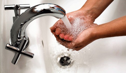 Hands being washed in a sink