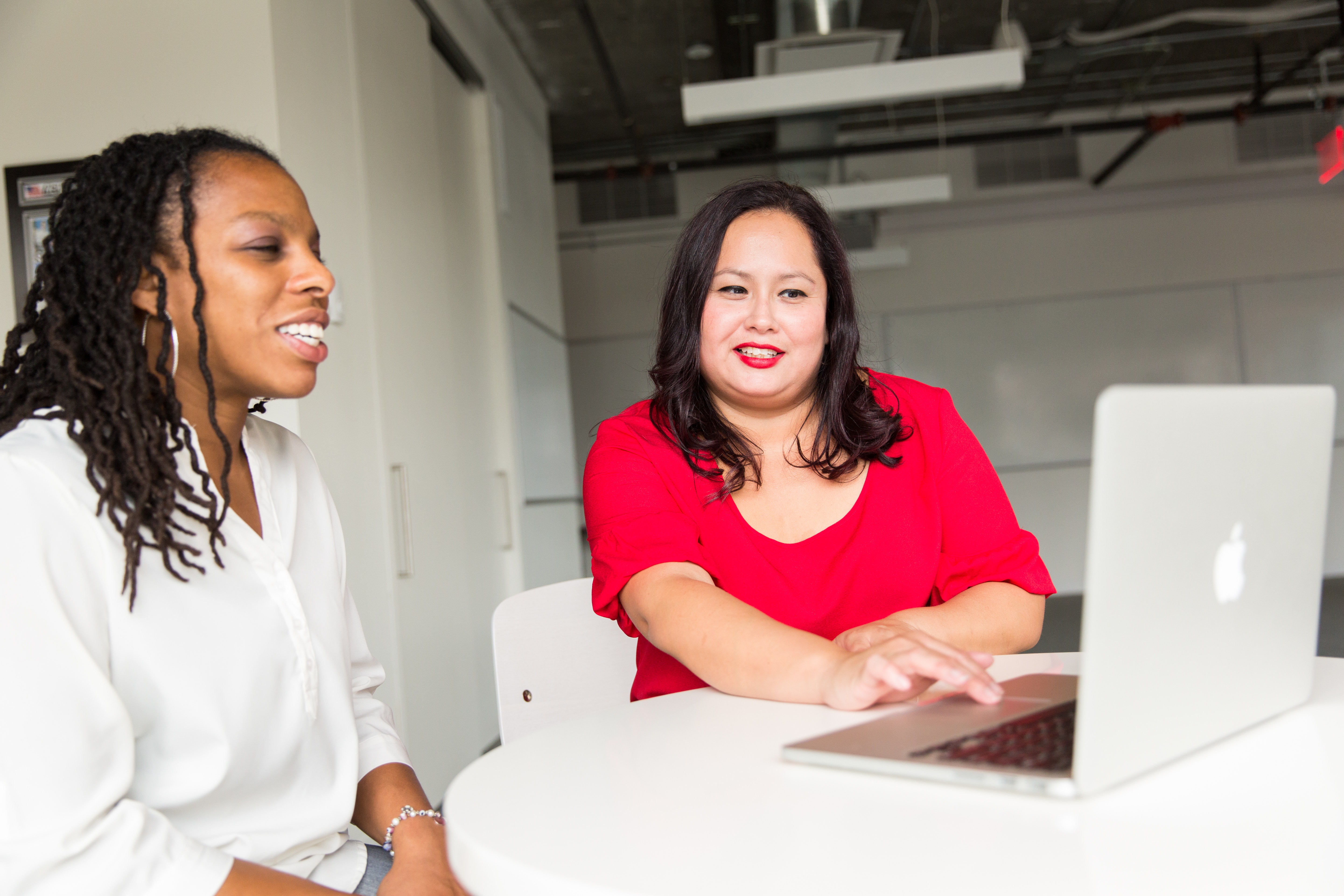 two woment looking at computer screen